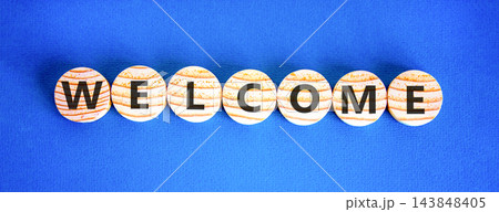 Welcome word symbol. Concept word Welcome on beautiful wooden circles. Beautiful blue background. Business welcome word concept. Copy space. Welcome word symbol. Concept word Welcome on beautiful wooden circles. Beautiful blue background. Business welcome word concept. Copy space. 143848405