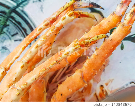 Snow crab legs on the counter of the fish market, close-up Snow crab legs on the counter of the fish market, close-up 143848670