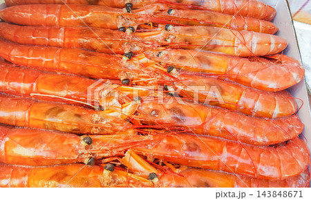Large frozen langoustines in a package on the counter of a fish market, close-up Large frozen langoustines in a package on the counter of a fish market, close-up 143848671