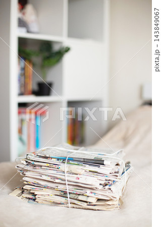 Stack of old newspapers tied with string for recycling Stack of old newspapers tied with string for recycling 143849067