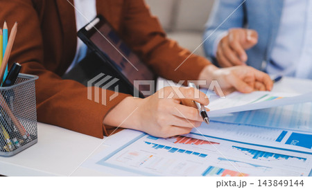 Business professional analyzing financial data on digital tablet dashboard with calculator and laptop, representing accounting software, ERP system integration, performance monitoring. Business professional analyzing financial data on digital tablet dashboard with calculator and laptop, representing accounting software, ERP system integration, performance monitoring. 143849144