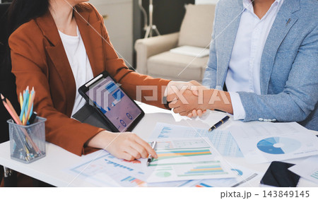 Business professional analyzing financial data on digital tablet dashboard with calculator and laptop, representing accounting software, ERP system integration, performance monitoring. 143849145