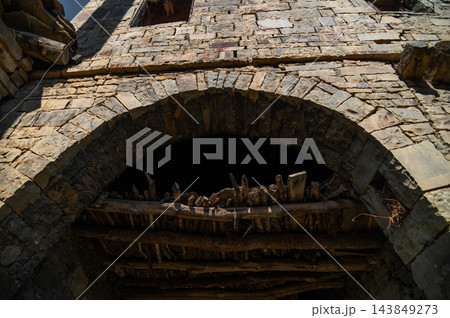Stone masonry archway with wooden ceiling supports Stone masonry archway with wooden ceiling supports 143849273