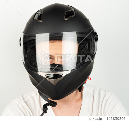 Headshot of man in black moto helmet Headshot of man in black moto helmet 143850203