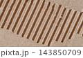 Macro texture of torn craft corrugated cardboard with exposed fluted layer. Close-up shot of torn brown corrugated cardboard surface, ribbed fluted paper structure, background design element 143850709