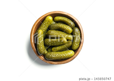 Marinated gherkins, pickled cucumbers in wooden bowl isolated 143850747