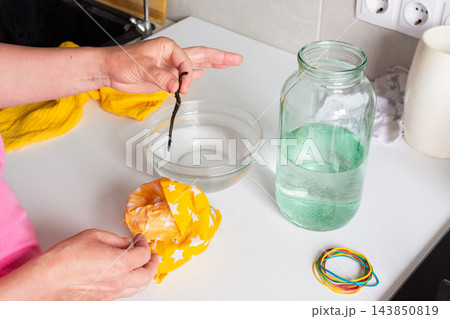 A woman carefully transfers medicinal leeches from a bag of peat into a jar of water. This process is part of hirudotherapy for health and wellness treatments A woman carefully transfers medicinal leeches from a bag of peat into a jar of water. This process is part of hirudotherapy for health and wellness treatments 143850819