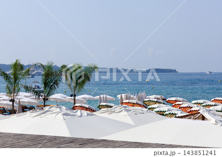 Luxury Cannes Beach Club with Colorful Umbrellas Luxury Cannes Beach Club with Colorful Umbrellas 143851241