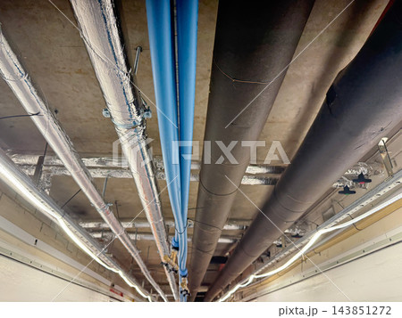 Industrial Ceiling Pipes and Ventilation System in Building Corridor. Industrial Ceiling Pipes and Ventilation System in Building Corridor. 143851272