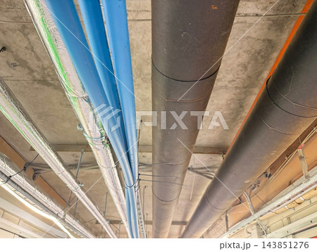 Industrial Ceiling Pipes and Ventilation System in Building Corridor. Industrial Ceiling Pipes and Ventilation System in Building Corridor. 143851276