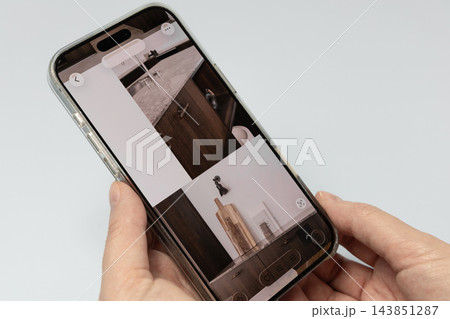 Viewing kitchen interior ideas on smartphone screen 143851287