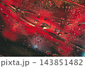 Water droplets on glass with intense red neon lighting reflection. Macro photograph of clear water drops condensed on glass surface with a dramatic deep red and dark neon glow background texture 143851482