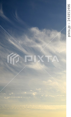 high cirrus clouds across a blue sky during sunset 143851496