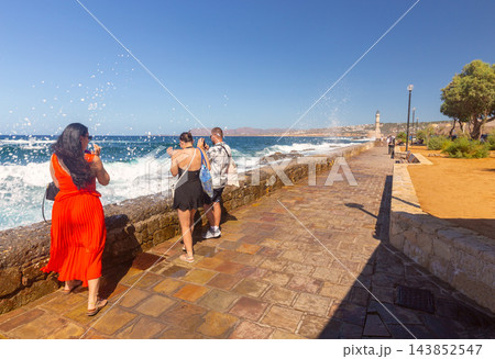 Tourists Photographing Powerful Sea Waves Near Chania Lighthouse in Crete Greece 143852547