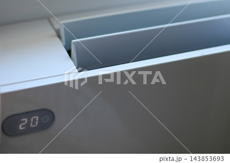 Air conditioner displaying twenty degrees on display 143853693