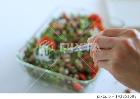 Fresh bean and tomato salad being prepared 143853695