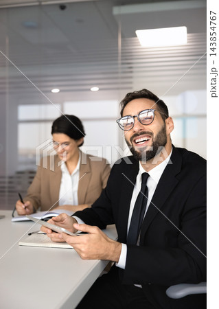 Team member holding digital tablet, attend corporate office meeting Team member holding digital tablet, attend corporate office meeting 143854767