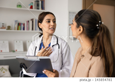 Doctor explaining diagnosis to patient during consultation Doctor explaining diagnosis to patient during consultation 143854781