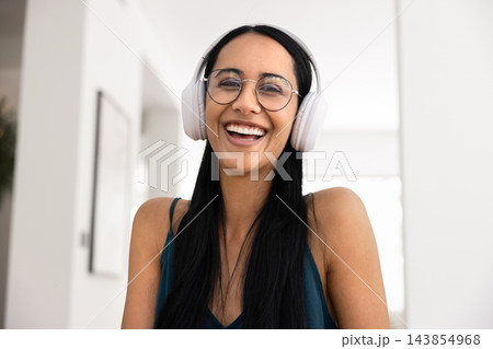 Portrait of woman wear glasses and headphones looking at camera 143854968