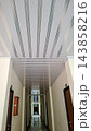 Modern Long Corridor Interior with White Striped PVC Ceiling Panel Design    143858216