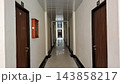 Empty Hotel Corridor with Wooden Doors and Tiled Floor Perspective    143858217