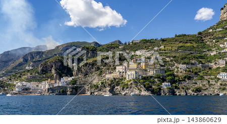 View of beautiful Amalfi town, Campania, Italy. Amalfi coast is most popular travel and holiday destination in Europe. Amalfi cityscape on coast line of mediterranean sea - view from sea 143860629
