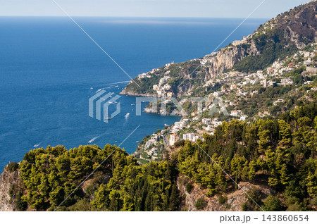 Aerial View from Ravello overlooking the Amalfi Coast in Italy. Aerial view of terraced fields, lush greenery, and the Mediterranean Sea Aerial View from Ravello overlooking the Amalfi Coast in Italy. Aerial view of terraced fields, lush greenery, and the Mediterranean Sea 143860654