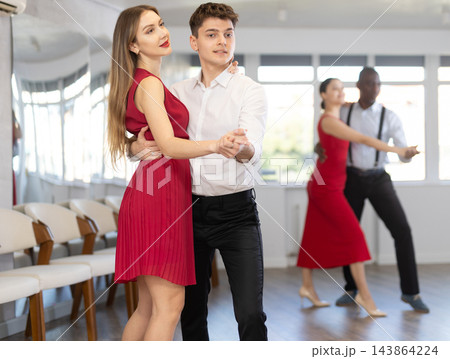 Young man and girl dancing waltz in couple during lesson at studio 143864224
