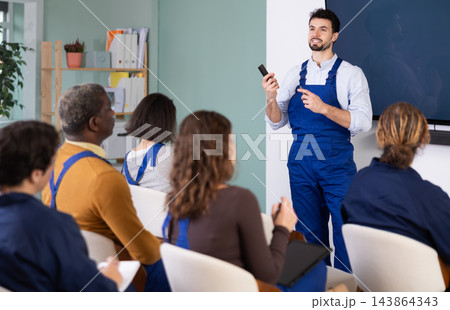 Male mentor teaches students new skills in vocational fields 143864343