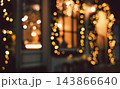 Night scene of out of focus golden Christmas bokeh festive lights framing windows and doorways. 143866640