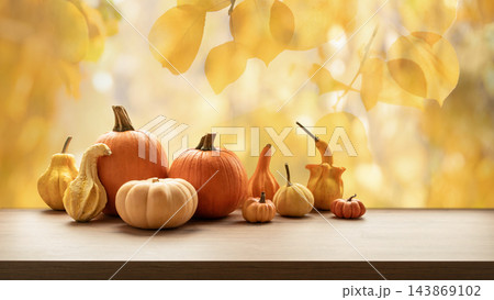 Autumn pumpkin harvest with golden leaves background Autumn pumpkin harvest with golden leaves background 143869102