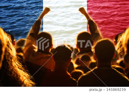 Silhouette of protesting crowd with raised fists against France national flag background. French protest, social unrest, rally, strike, political demonstration, and revolution concept 143869239