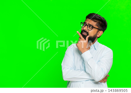 Indian man touching chin with thoughtful face showing idea development thinking process chroma key 143869505