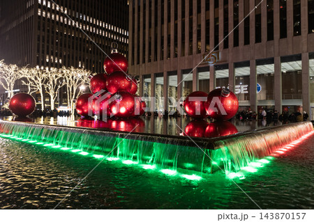 New York City, USA - December 24, 2023: Merry Christmas. Christmas time in NYC. Xmas ball and fountain illumination. NYC Xmas illumination. Illuminated fountain decorated with Christmas ball 143870157