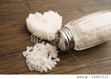 Sodium chloride sea salt with salt shaker. Sodium chloride sea salt with salt shaker. 143871117