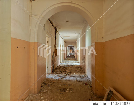 Arched corridor with yellow and white walls and rubble on the floor in an abandoned sanatorium in Arzni, Armenia Arched corridor with yellow and white walls and rubble on the floor in an abandoned sanatorium in Arzni, Armenia 143874828
