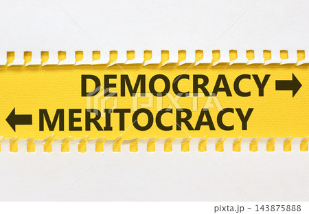 Democracy or meritocracy words symbol. Concept words Democracy Meritocracy on beautiful yellow paper. Beautiful white background. Business democracy meritocracy concept. Copy space Democracy or meritocracy words symbol. Concept words Democracy Meritocracy on beautiful yellow paper. Beautiful white background. Business democracy meritocracy concept. Copy space 143875888