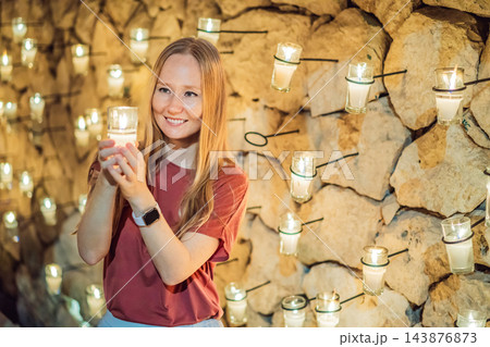 Happy visitor with a votive candle at a Mexican cultural event. Happy visitor with a votive candle at a Mexican cultural event. 143876873