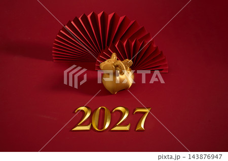 Golden ram for the 2027 lunar new year with red paper fans 143876947