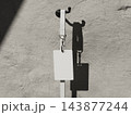 Blank ID card on a lanyard hanging from a black wall hook on a sunlit concrete wall 3D render 143877244