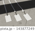 Three blank ID cards with lanyards in a diagonal flat lay on concrete 3D render 143877249