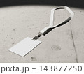 Blank ID card with a twisted lanyard on a concrete floor under a spotlight 3D render 143877250