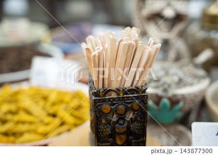 Disposable wooden stirrers standing in a decorative holder at a local food service counter in Egypt. Cafe supplies takeaway beverages and local trade Disposable wooden stirrers standing in a decorative holder at a local food service counter in Egypt. Cafe supplies takeaway beverages and local trade 143877300
