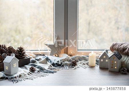 Cozy Christmas window decorations with glowing ceramic houses Cozy Christmas window decorations with glowing ceramic houses 143877858