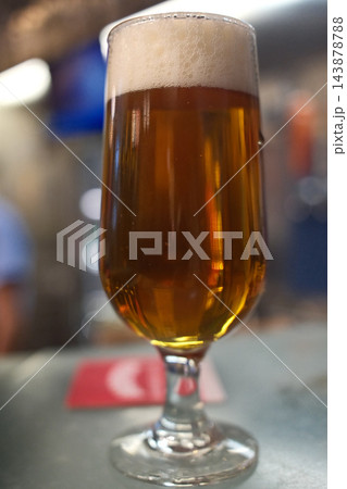 Cold Beer Served in a Glass Mug with Golden Color and Foam Cold Beer Served in a Glass Mug with Golden Color and Foam 143878788