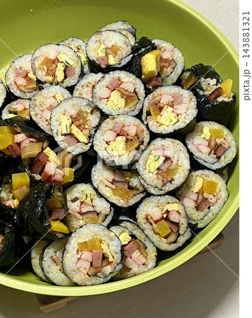 Delicious kimbap rolls filled with fresh vegetables, seasoned rice, and savory proteins, all wrapped in crisp seaweed. A perfect combination of flavor and texture in every bite. Delicious kimbap rolls filled with fresh vegetables, seasoned rice, and savory proteins, all wrapped in crisp seaweed. A perfect combination of flavor and texture in every bite. 143881321