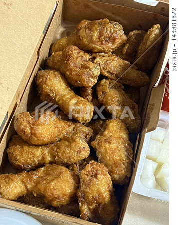 Crispy Korean fried chicken, perfectly glazed with a sweet and spicy sauce. Ideal for food photography and menus, showcasing the irresistible crunch and flavor of this beloved dish. Crispy Korean fried chicken, perfectly glazed with a sweet and spicy sauce. Ideal for food photography and menus, showcasing the irresistible crunch and flavor of this beloved dish. 143881322