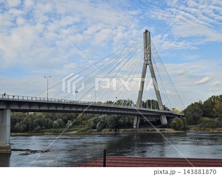 Warsaw, Poland - October 5, 2026: Side View of Swietokrzyski Bridge and Vistula Waterfront Warsaw, Poland - October 5, 2026: Side View of Swietokrzyski Bridge and Vistula Waterfront 143881870