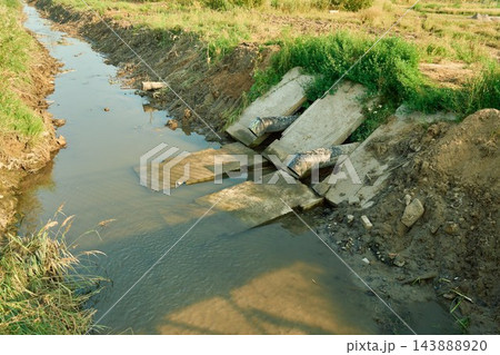 Industrial drainage system with heavy plastic sewage pipes discharging dirty wastewater from concrete structures 143888920