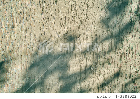Sunlight and shadow play on a rough white facade plaster surface Sunlight and shadow play on a rough white facade plaster surface 143888922